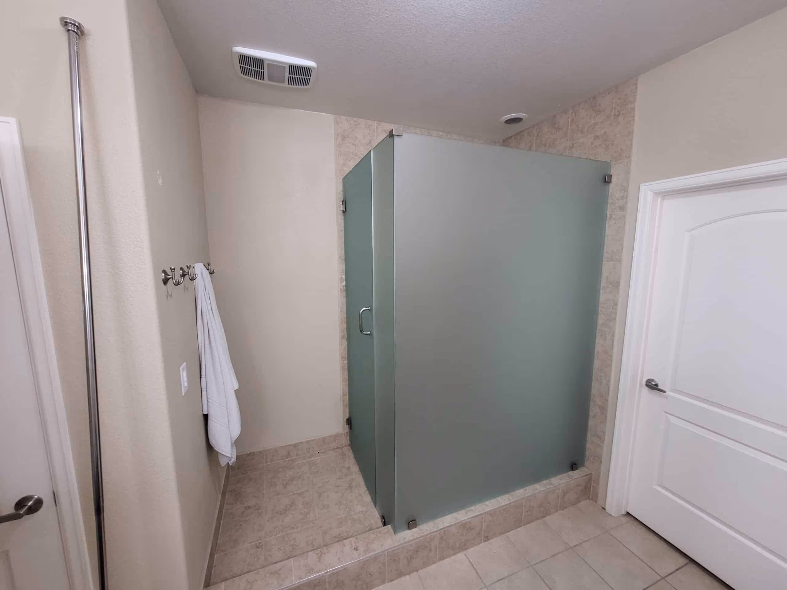 Bathroom shower niche with built-in shelving for toiletries in a tiled wall.