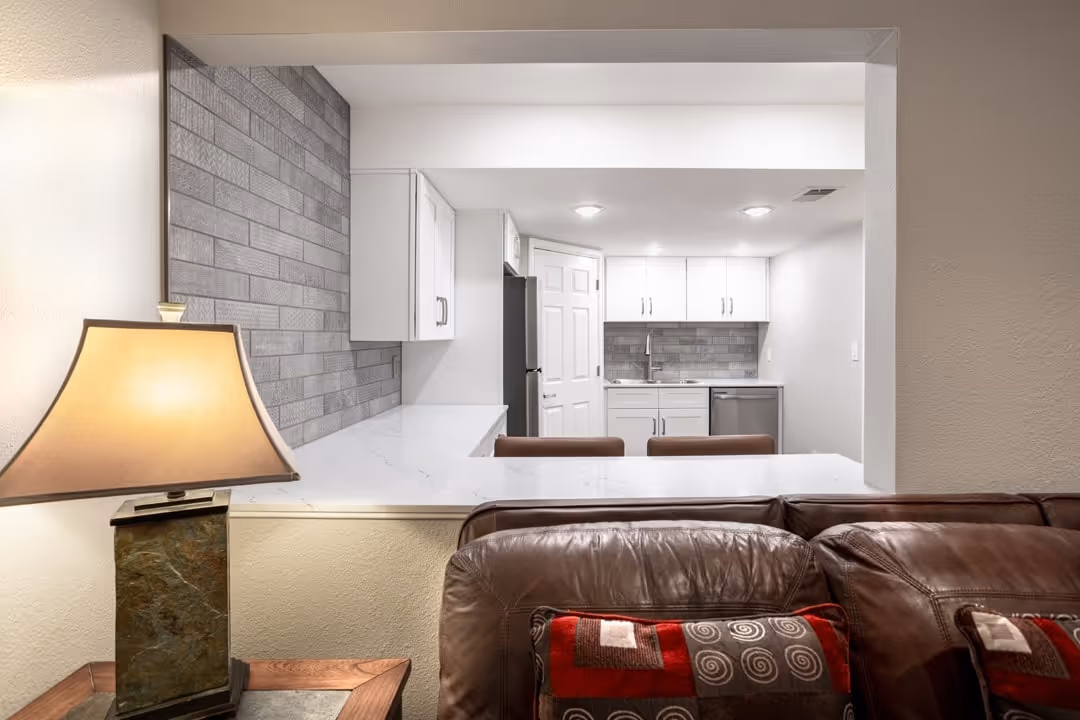 Compact kitchenette with white cabinets