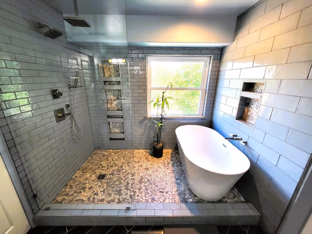 Bathroom with vibrant tropical wallpaper and a white freestanding tub.